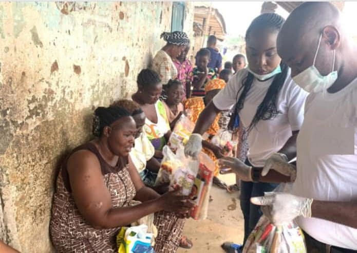 Volunteers handing food packages to families